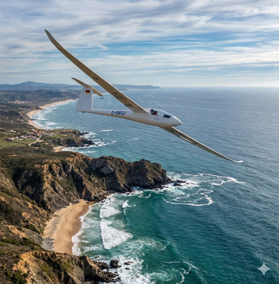 Ventus scale sailplane soaring over the ocean coast